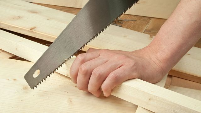 Someone cutting wood
with a hand saw.